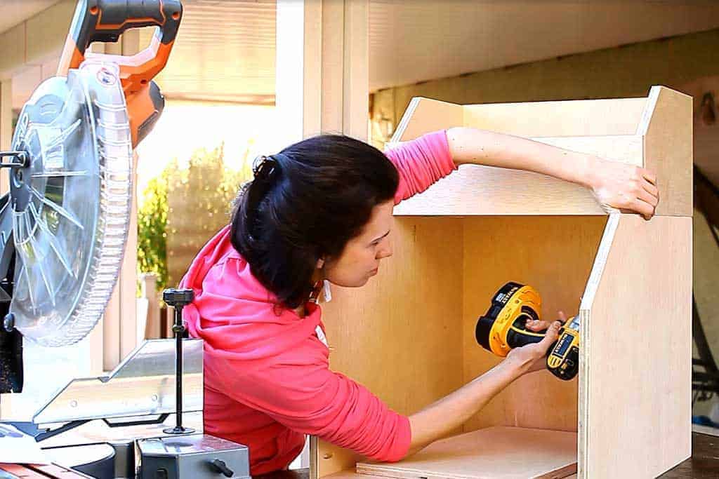 attaching top piece of the DIY Storage for Toys