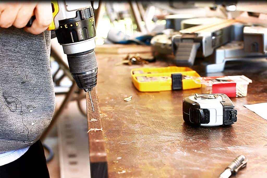 drilling holes for the cup hooks DIY Family Calendar Board