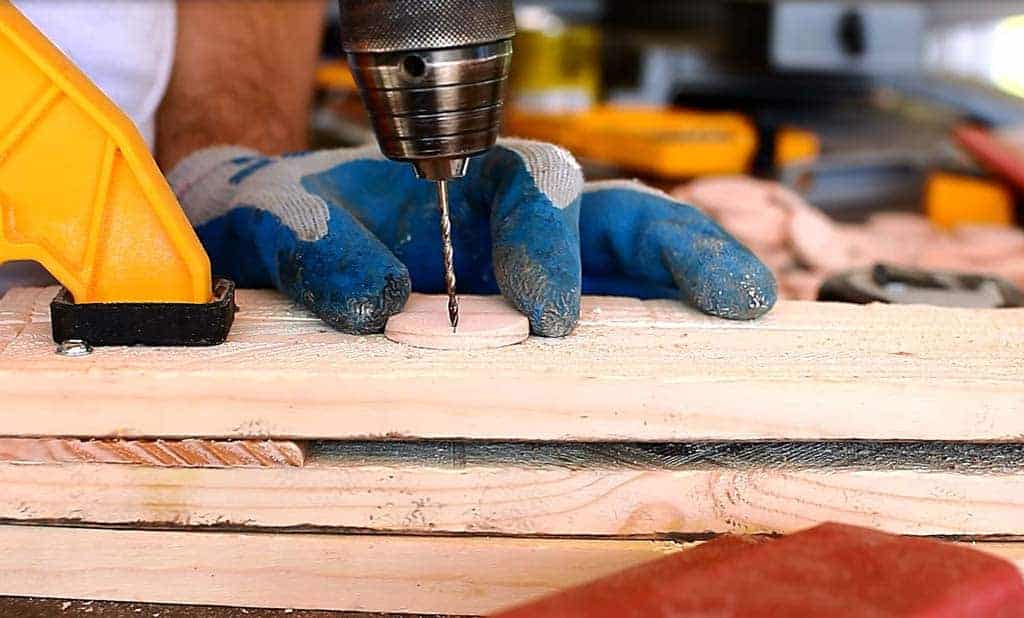 drilling a hole on the wood disc for DIY Family Calendar Board