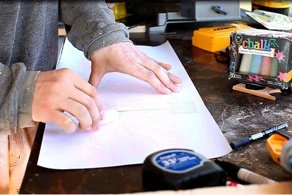 applying chalk on the back of the template