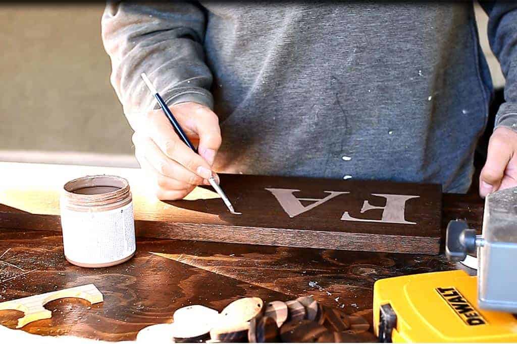 painting the text of the DIY Family Calendar Board