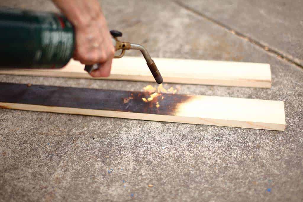 burning wood with torch for DIY Wooden Table Centerpiece