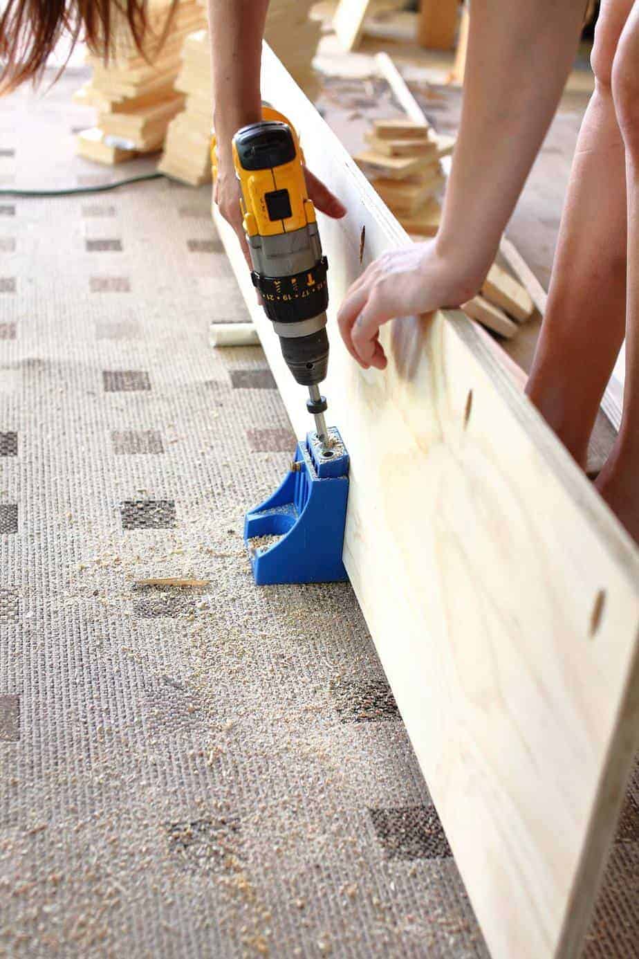 drilling pocket holes for the DIY Corner Storage Bench