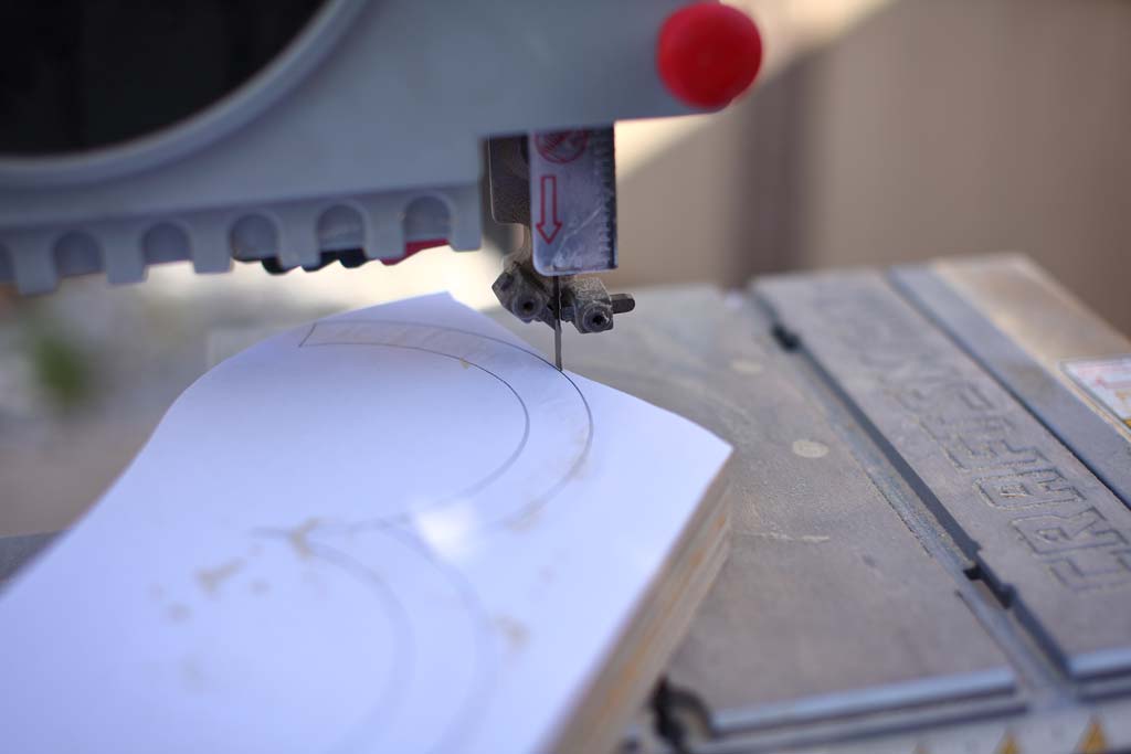 using a saw to cut out cloud shapes