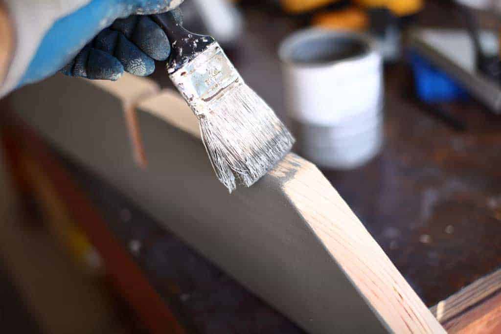 paining the base of the DIY Cornhole Scoreboard