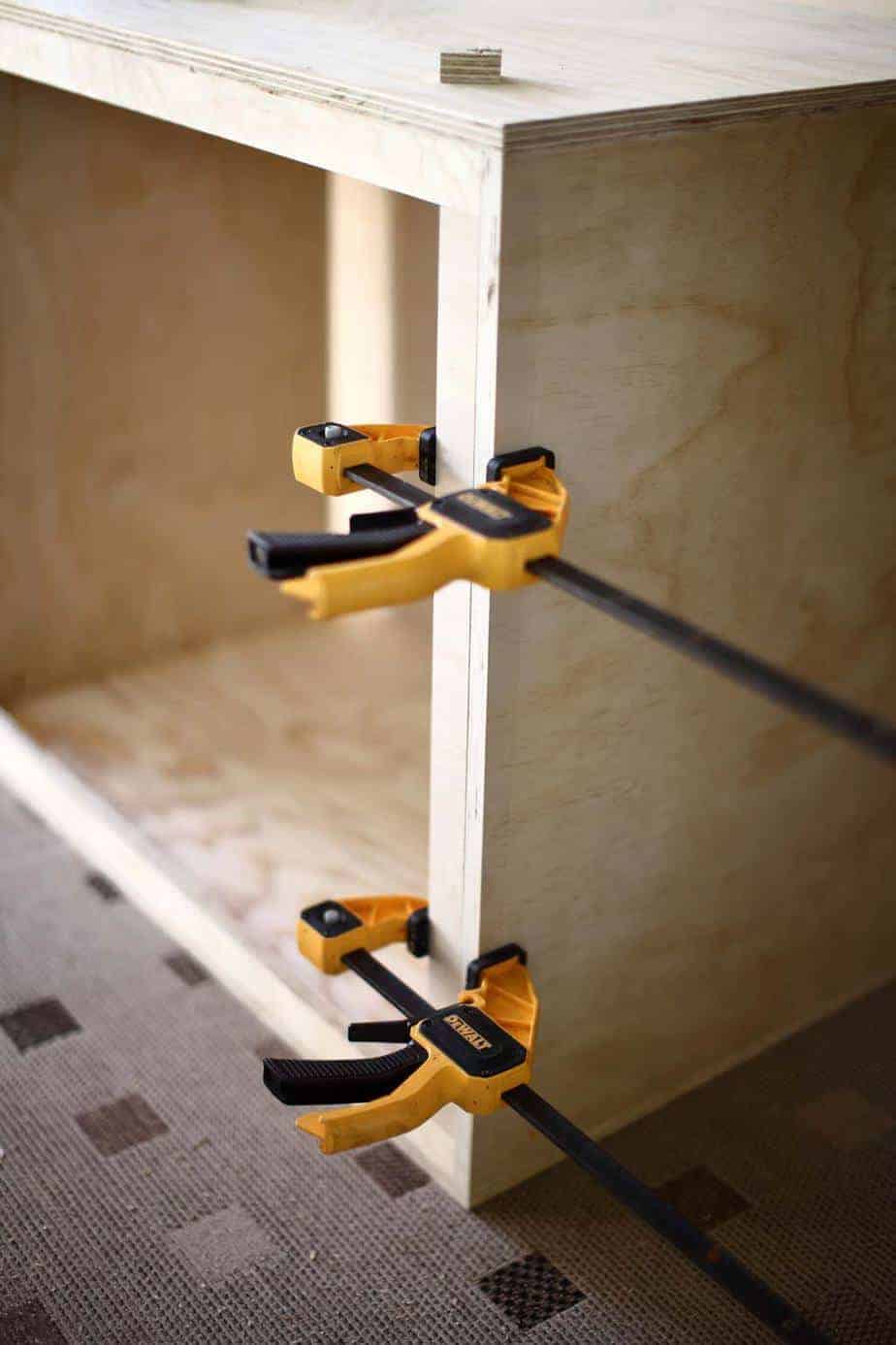 installing plywood boards around the perimeter of the dresser