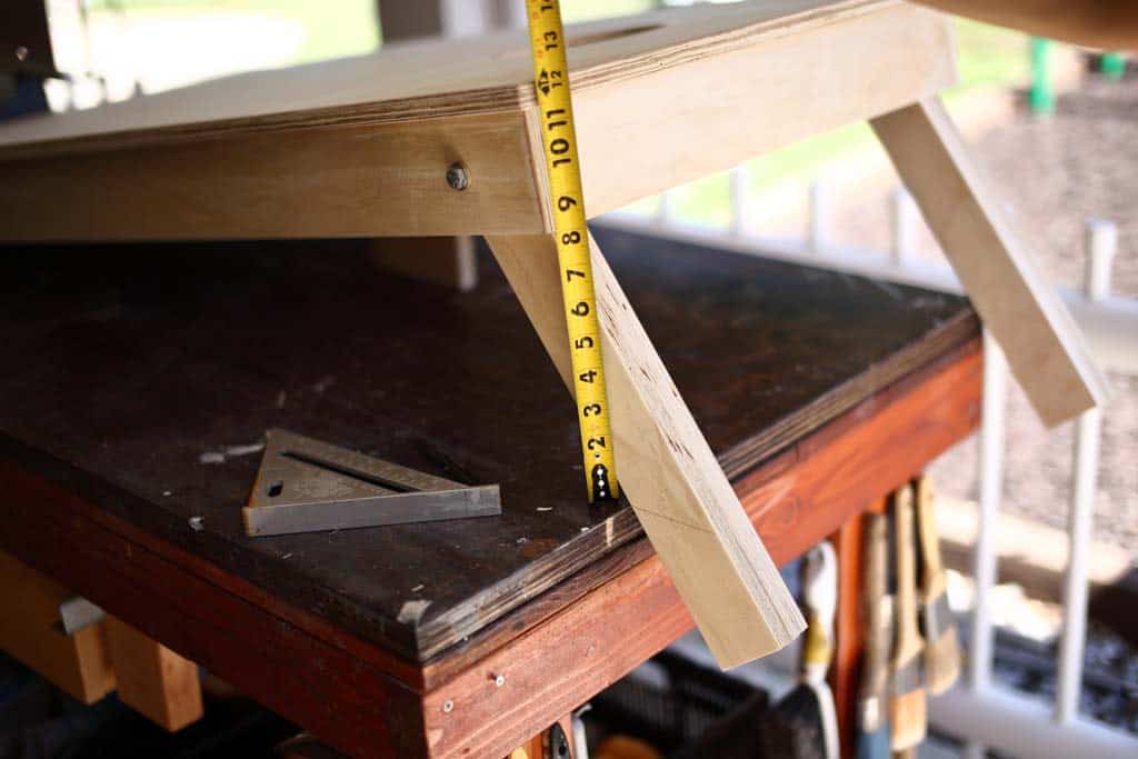 cutting off extra length from legs of the DIY Cornhole Boards