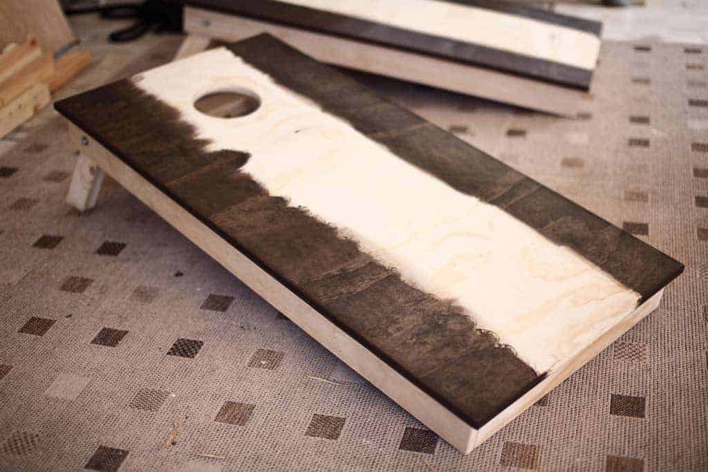 staining DIY Cornhole Boards