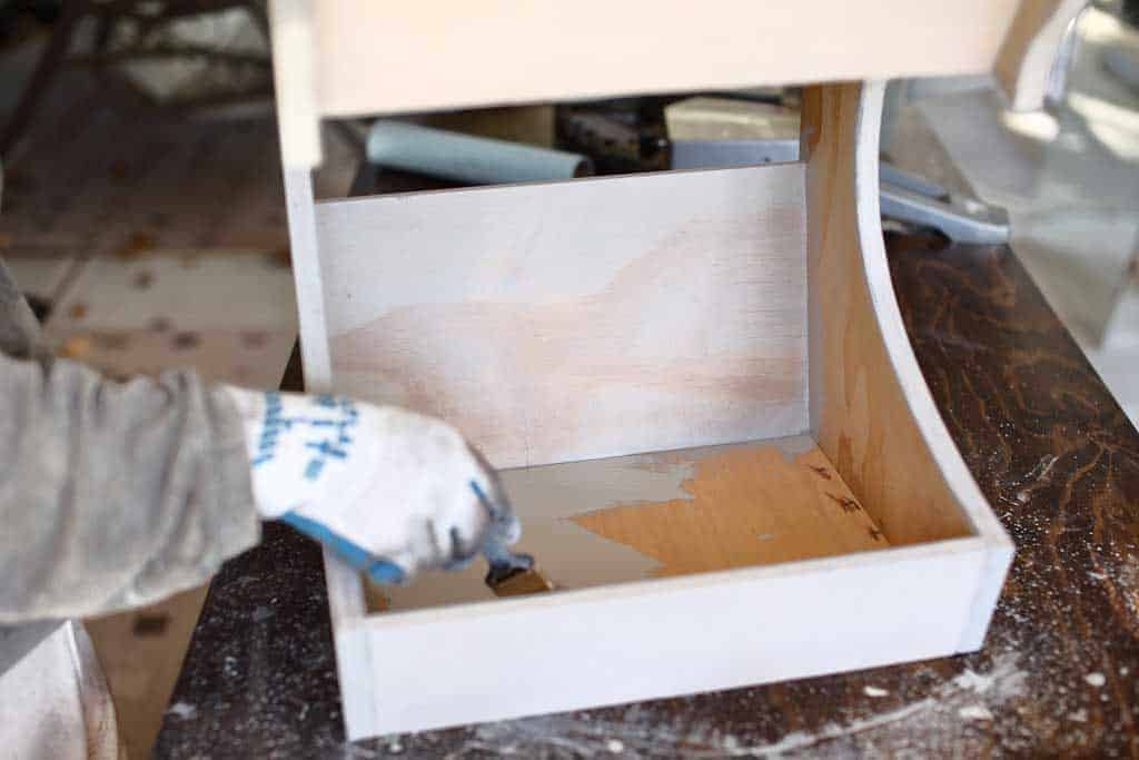 applying pre stain on DIY Fruit Storage Container