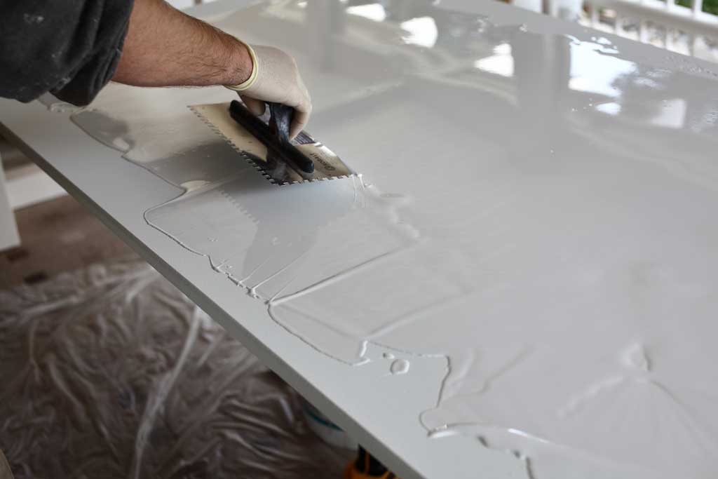 spreading epoxy over table top