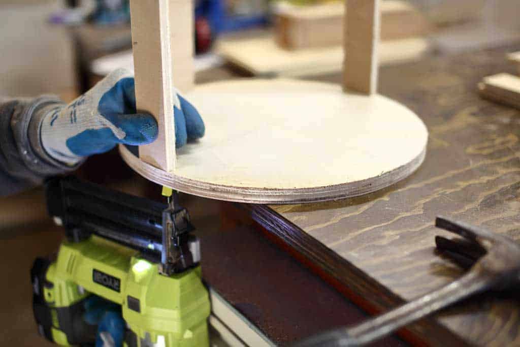 using staple gun to attach wood to round disk