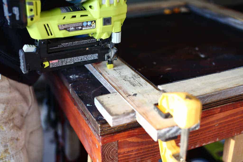 using nail gun to secure wood for mirror frame