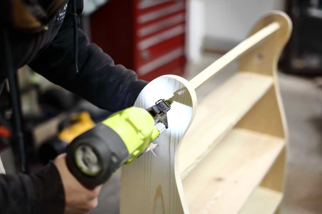 using nail gun to attach upper lip for DIY Curved Shelf