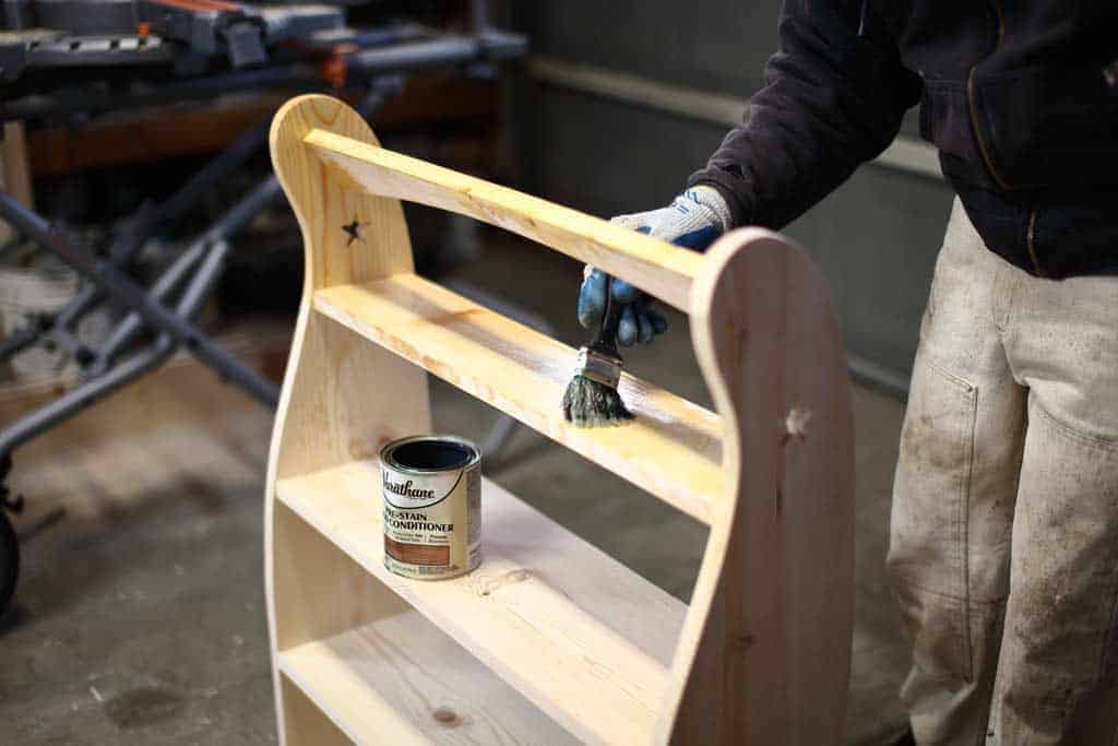applying coat for pre-stain on DIY Curved Shelf