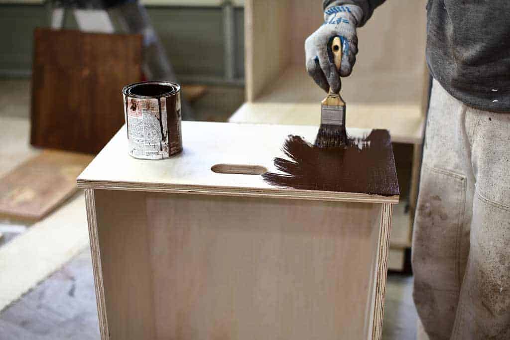 staining front board of the drawer box of the DIY Mudroom Locker
