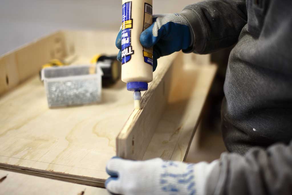 gluing boards together for the base of the DIY Mudroom Locker