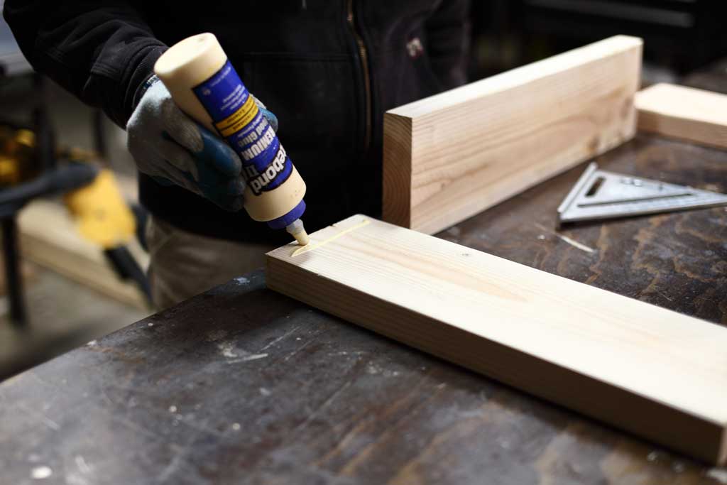 using wood glue to attach boards for DIY Sensory Table