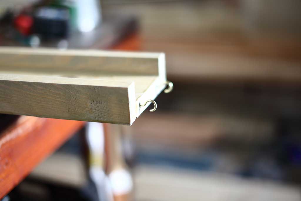 attaching cup hooks for water ramps on DIY Sensory Table
