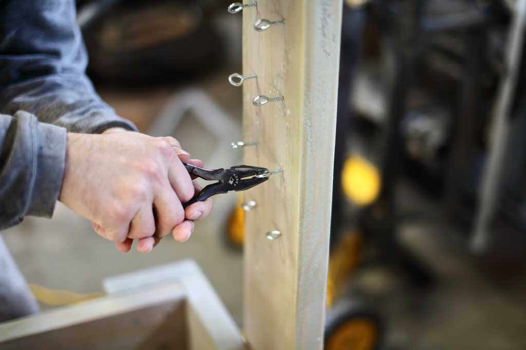 attaching eye hooks for DIY Sensory Table with water ramps
