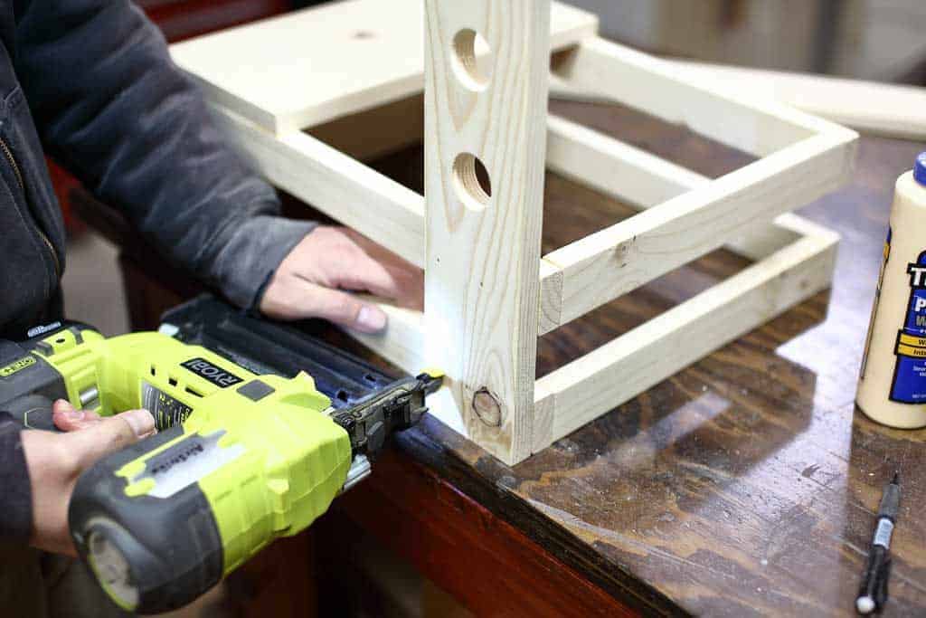 nailing the back leg of the DIY Toddler Step Stool