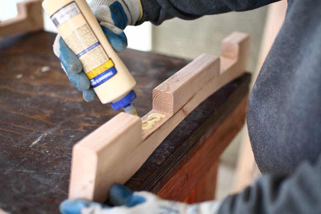 applying wood glue in the 2x4 notch cut out
