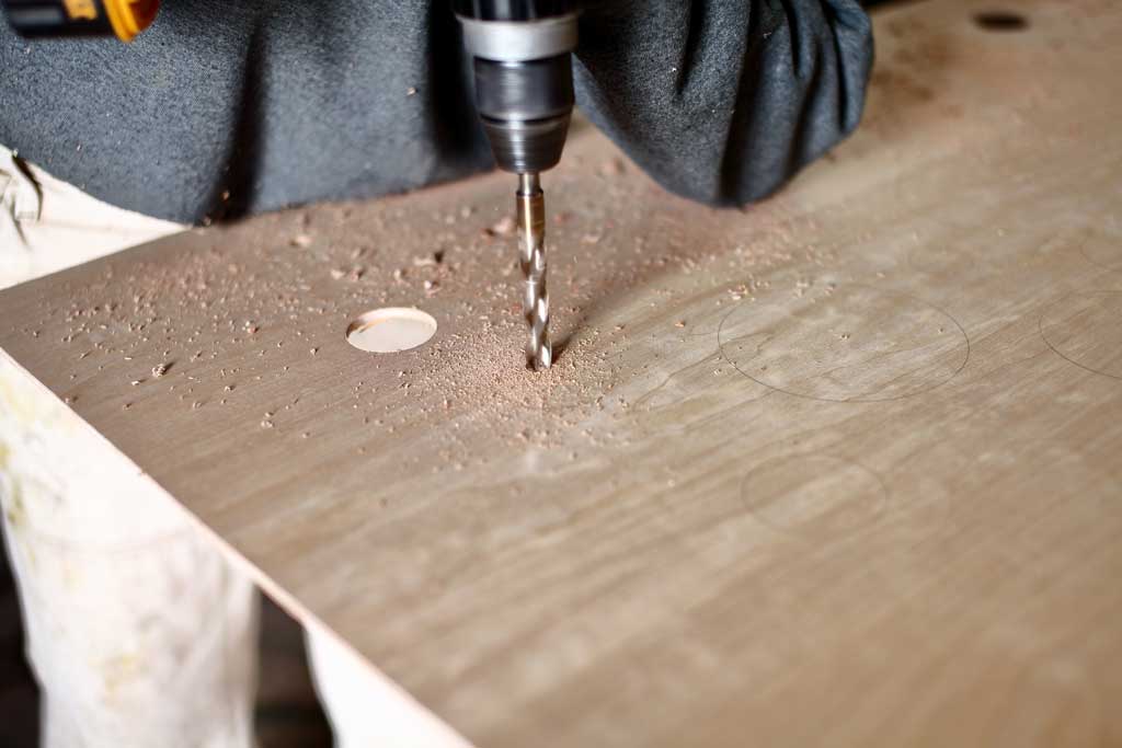 drilling holes in the plywood