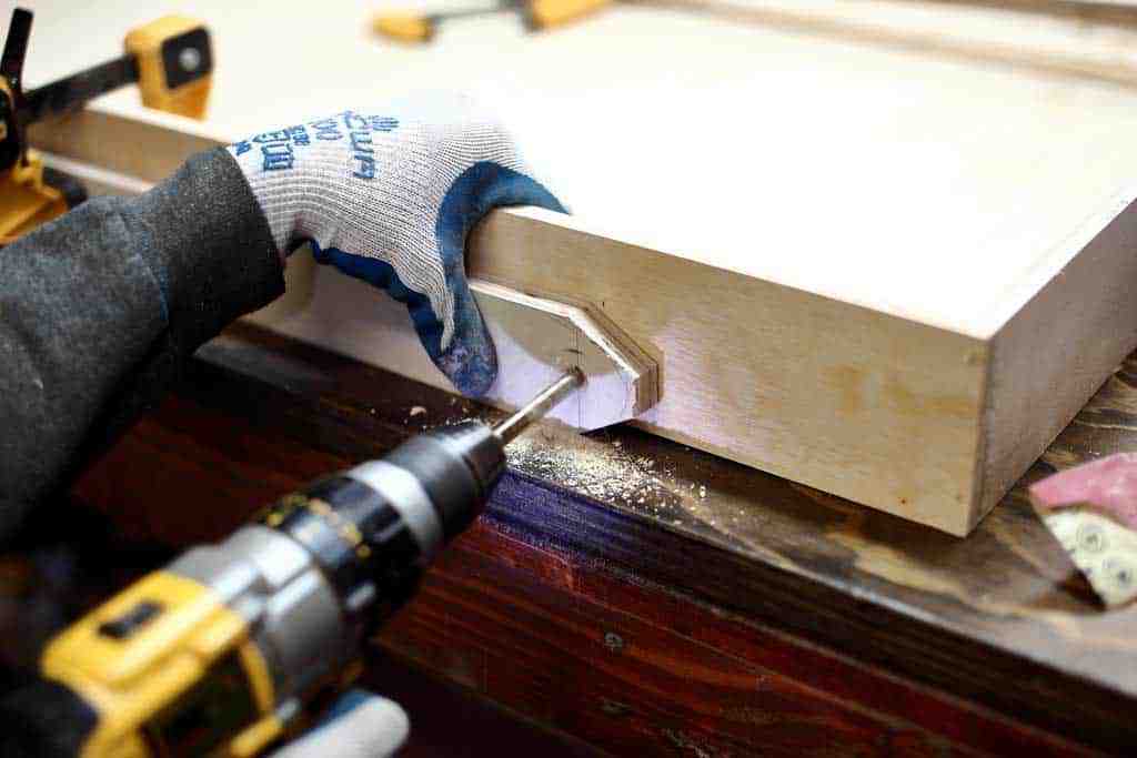 drilling hole for the legs of the wall ball game