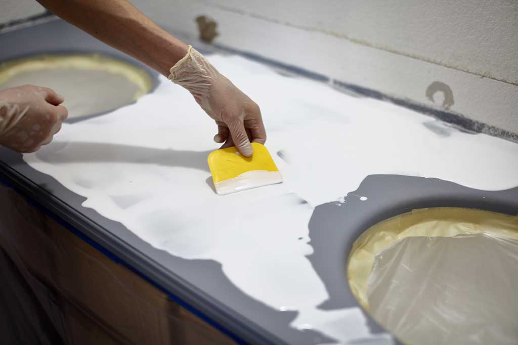 spreading epoxy over bathroom vanity