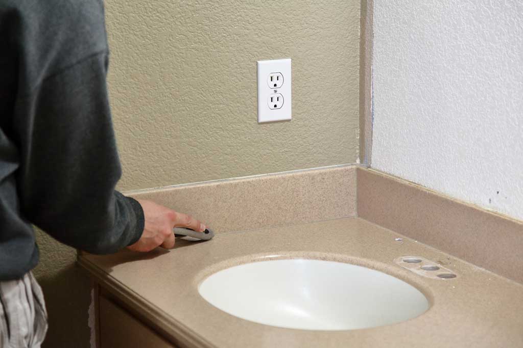 cutting silicone to remove backsplash