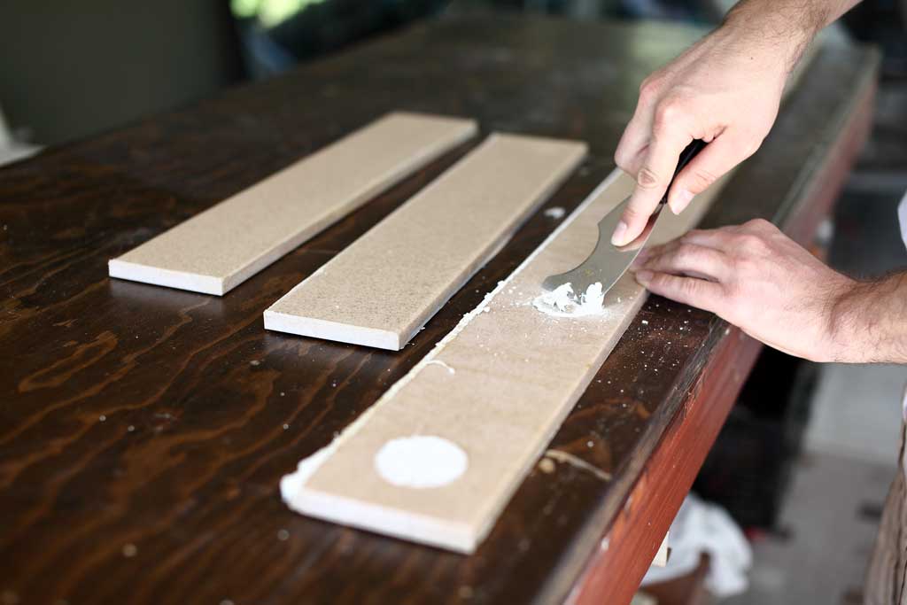 scraping off old sealant from backsplash