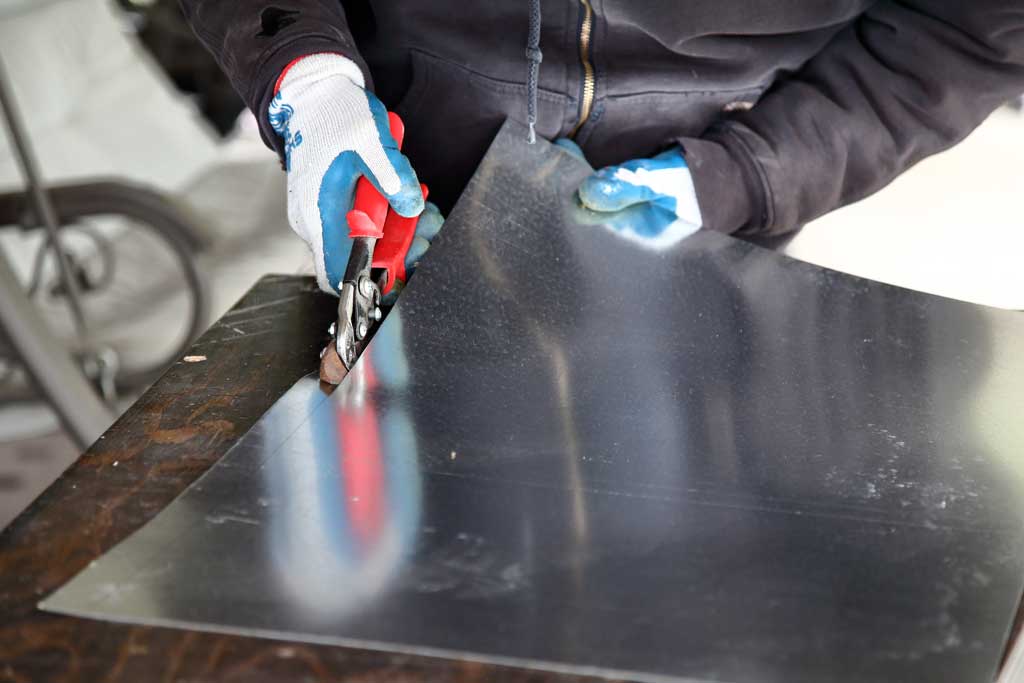 cutting flat sheet of metal to make control arm for DIY plantation shutters