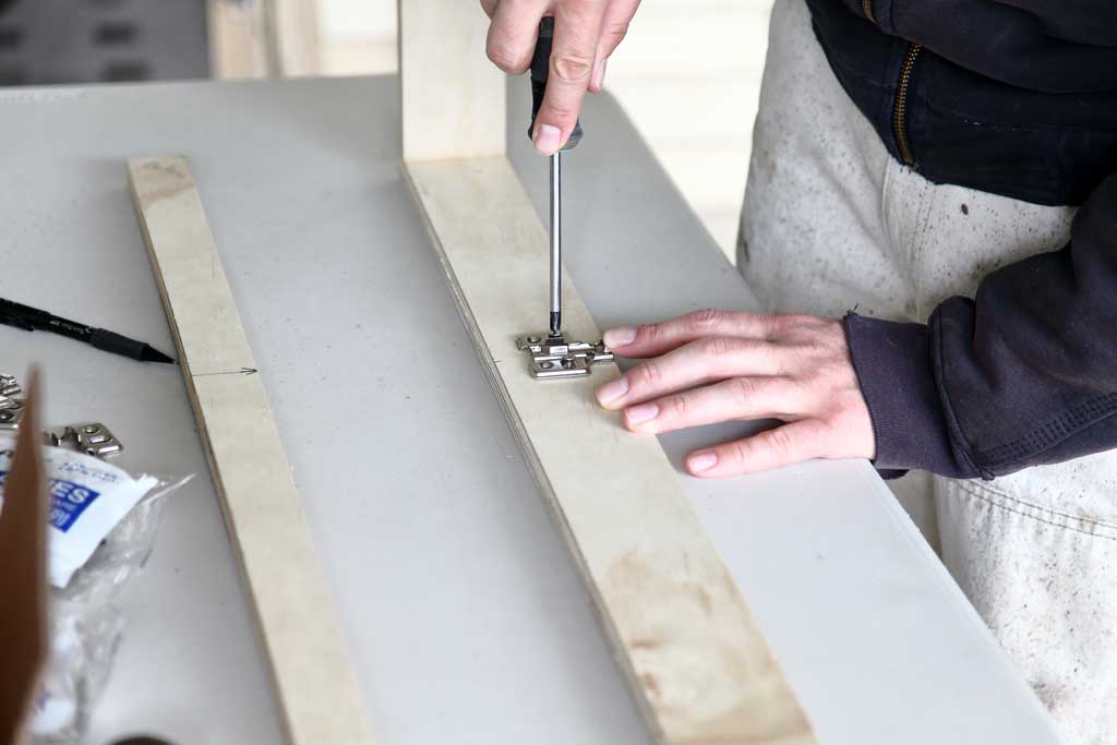 attaching the mounting plate of the hinges