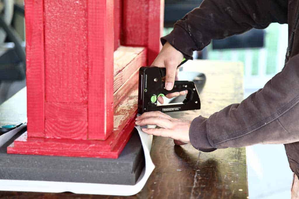 stapling fabric to the plywood for the diy workout bench press