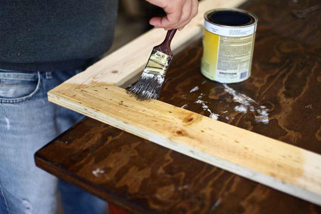 applying pre-stain on DIY mirror frame