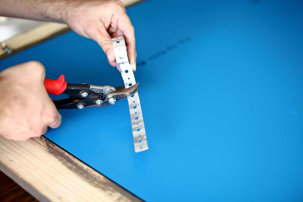 cutting plumbers strap with snips