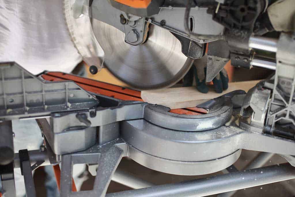 using miter saw to cut wood for the DIY mirror frame