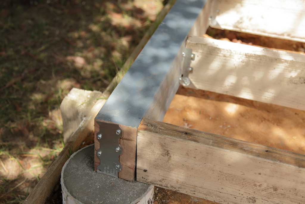 Simpson strong tie attaching to foundation of DIY Chicken Coop
