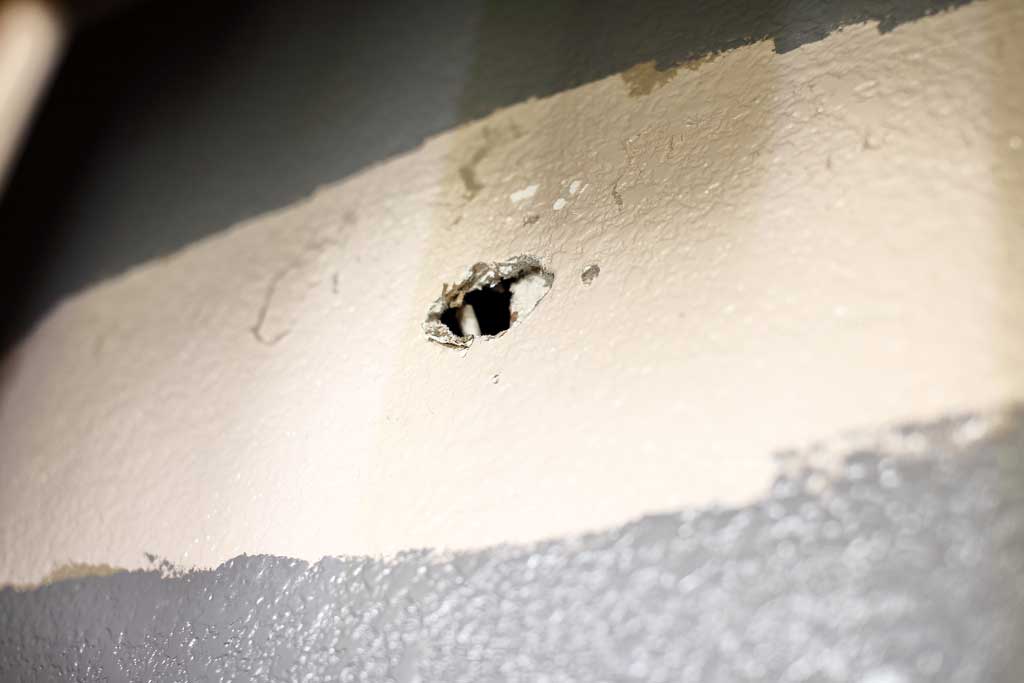 hole in the drywall from old light fixture