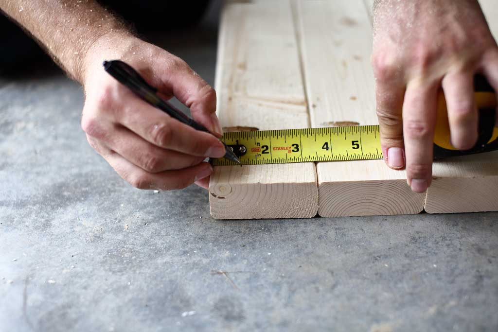 pulling a measurement for the legs on the tabletop