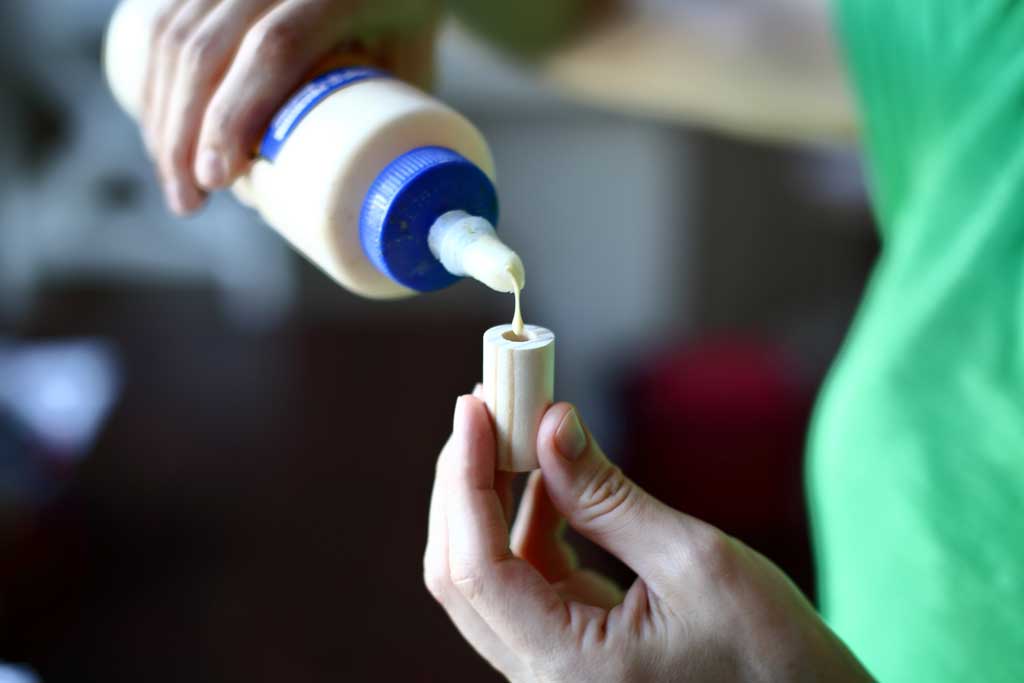 applying wood glue for the chess piece