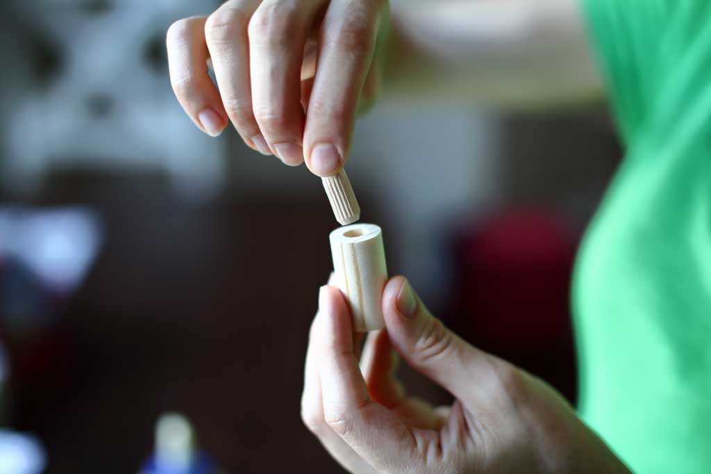 inserting dowel into chess piece