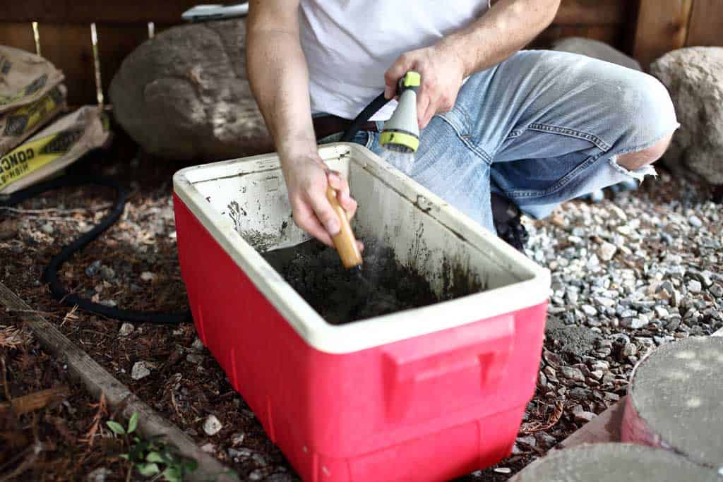 mixing concrete in the container for diy stepping stone