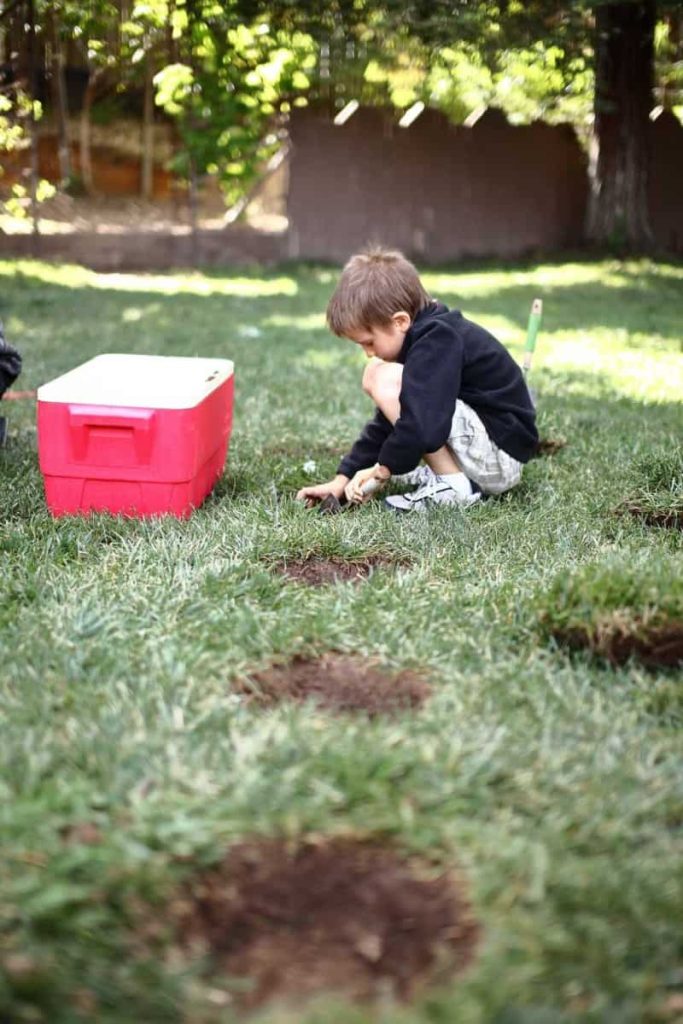 boy digging out hole for diy stepping stone
