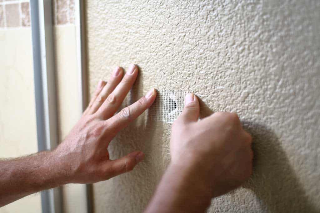 taping mesh screen over hole on drywall