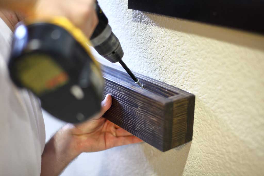 screwing in DIY Wooden Towel Bar