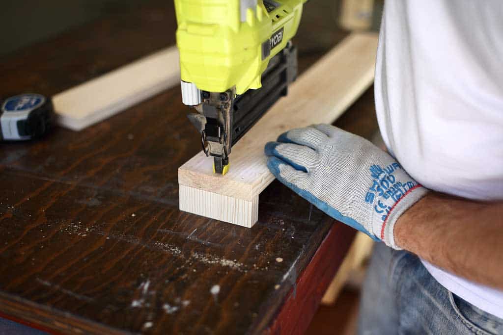 using nail gun on the DIY towel bar