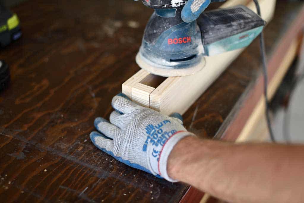 using orbital sander for DIY towel bar