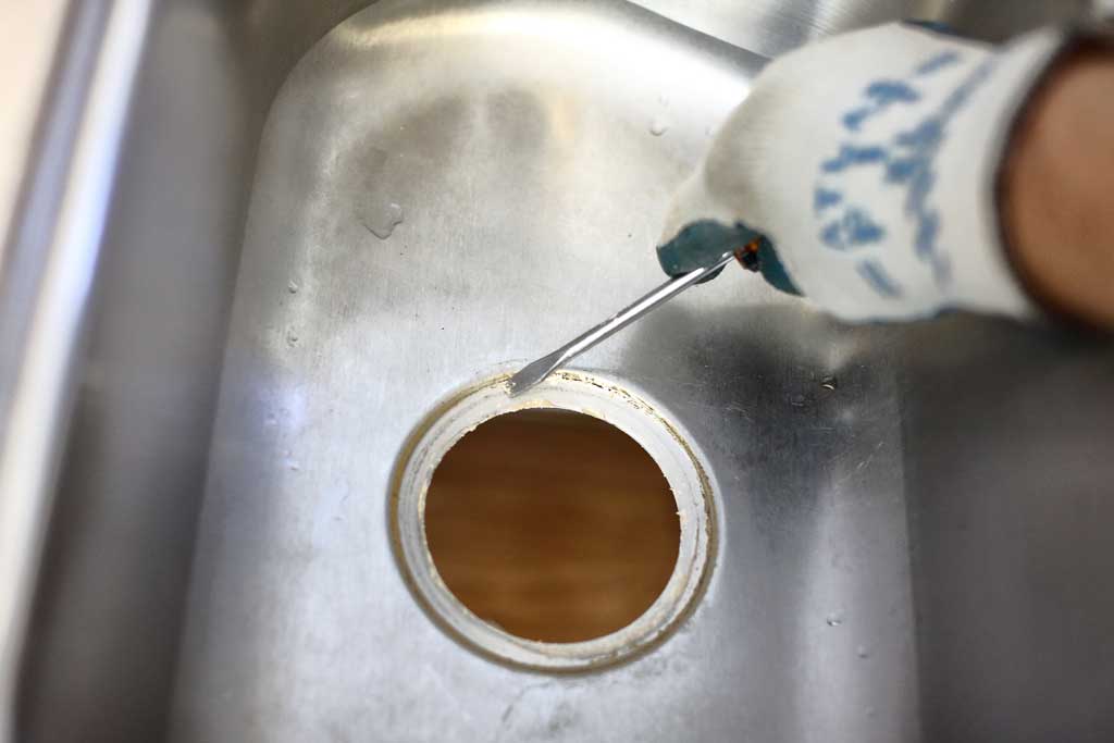 cleaning sink hole to install new garbage disposal