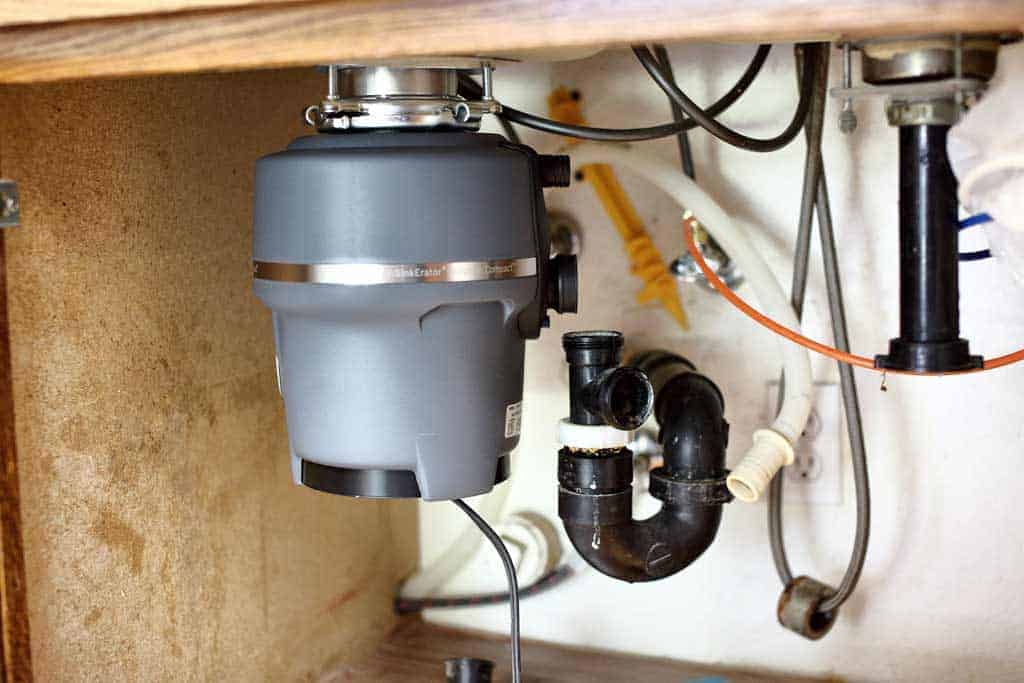 attaching garbage disposal to upper mounting assembly