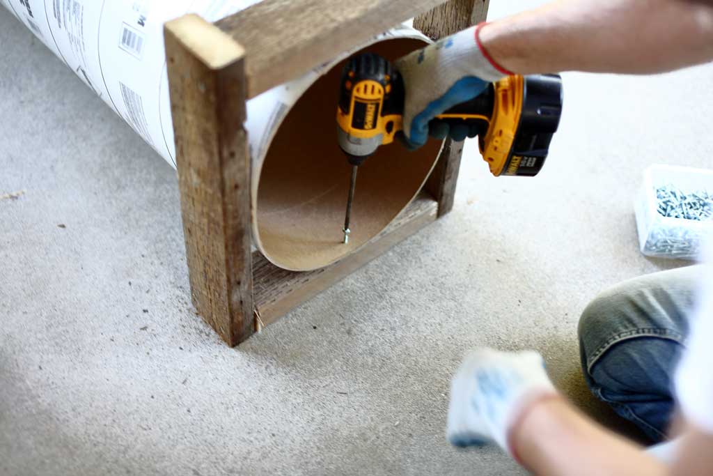 attaching concrete form tube to the frame of the DIY skunk trap